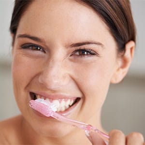woman smiling brushing teeth