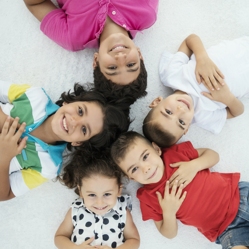 Portrait of happy children lying down