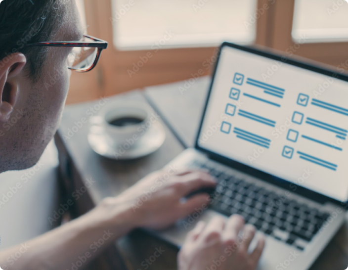 man sitting at computer filling out forms