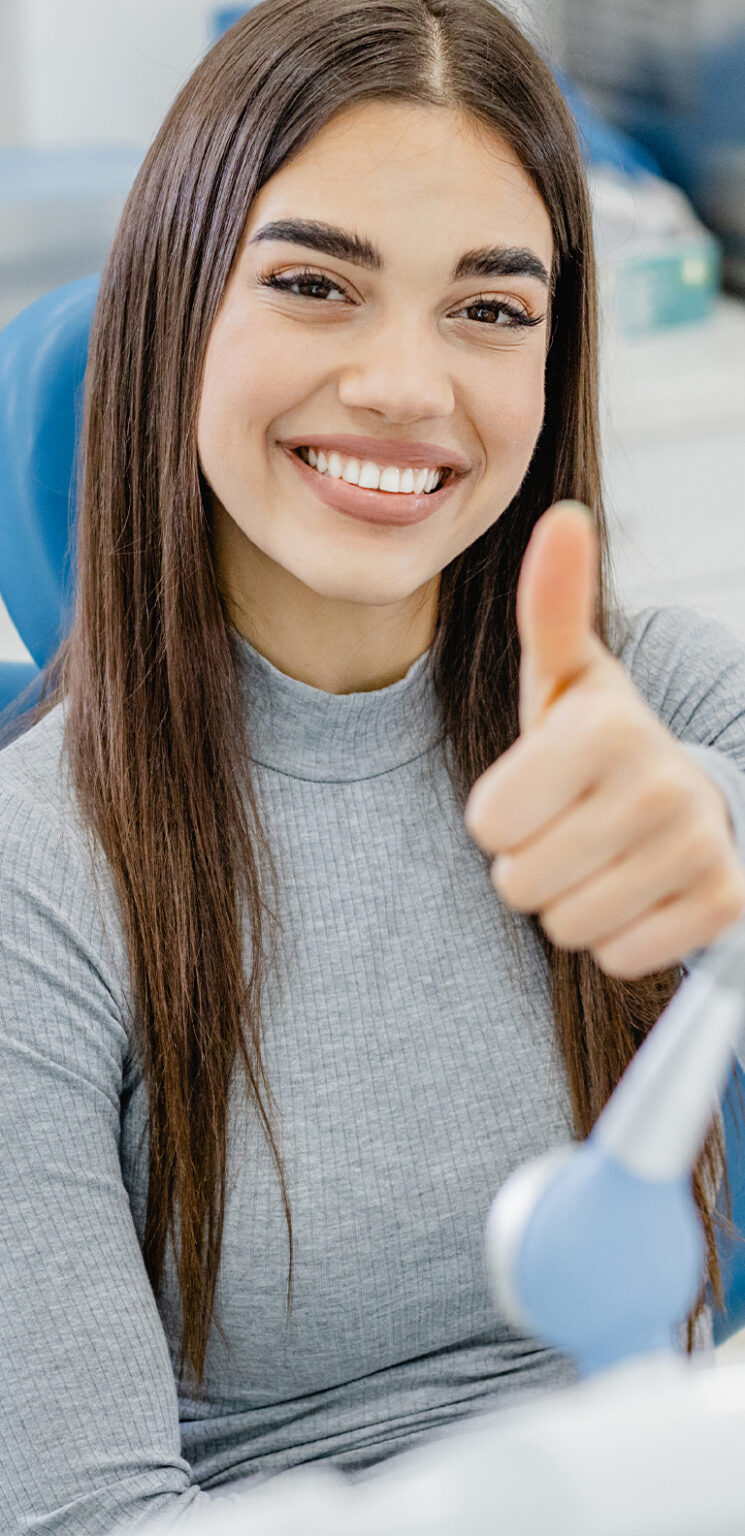 smiling patient giving a thumbs up