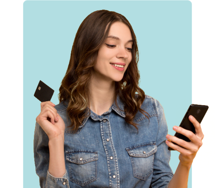 woman holding credit card and looking at phone