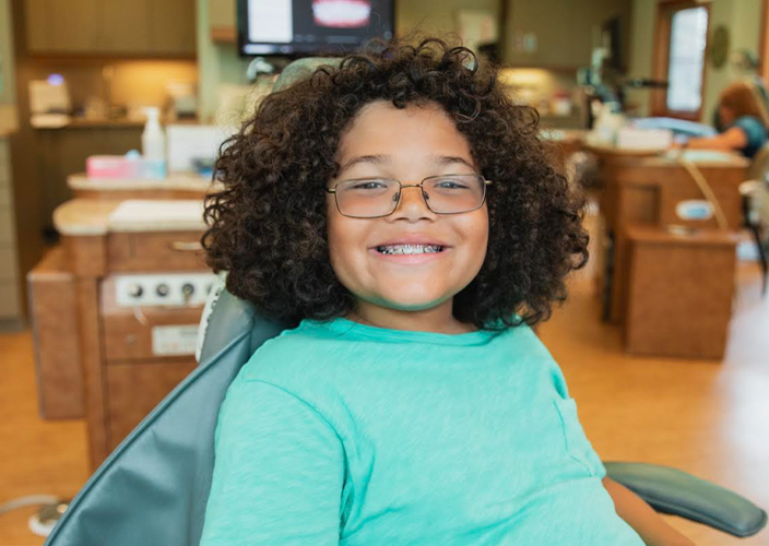 smiling carlyn phucas patient wearing braces 1
